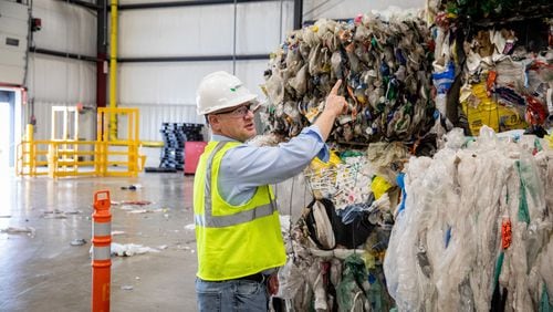 Bob Powell, a Georgia Tech graduate and CEO and founder of Brightmark stands among bales of plastic wastes at a processing plant in Indiana. The company plans to build a massive plastic waste processing plant in Georgia that will turn plastic into diesel fuel, naptha and wax. Powell wants one day to turn the plastic into new plastic, helping solve the massive problem of plastic pollution. But that process isn't economically viable at the moment. Photo courtesy of Brightmark.