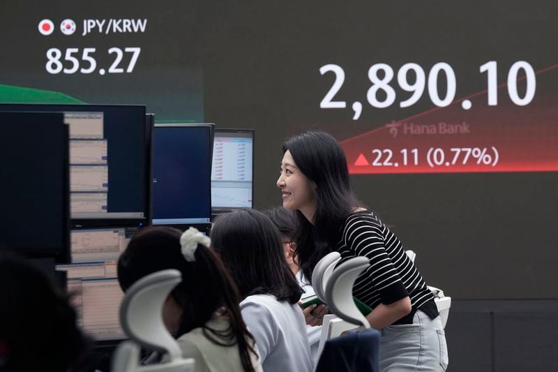 A currency trader watches monitors near the screen showing the Korea Composite Stock Price Index (KOSPI) at the foreign exchange dealing room of the KEB Hana Bank headquarters in Seoul, South Korea, Thursday, July 11, 2024. (AP Photo/Ahn Young-joon)