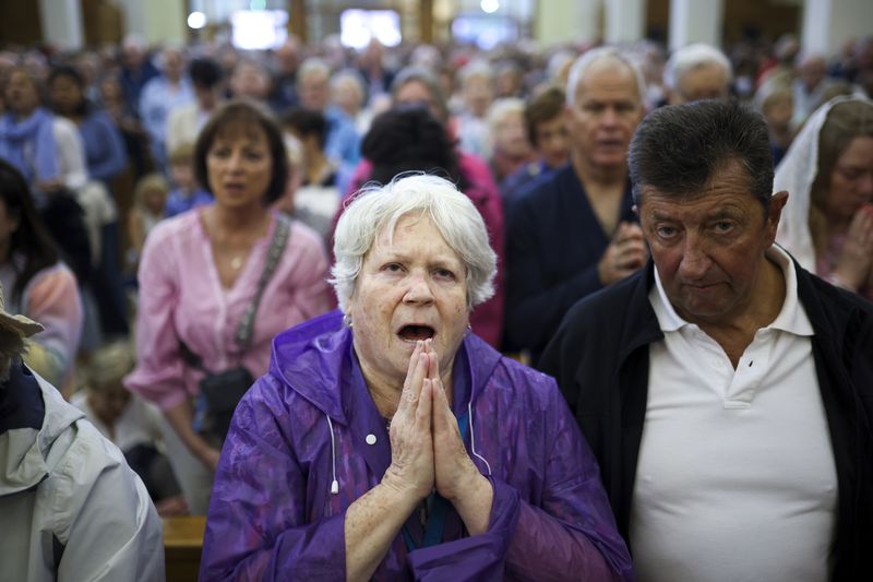 Pilgrims say their prayers inside the St. James Church in Medjugorje, Bosnia, Thursday, Sept. 19, 2024. (AP Photo/Armin Durgut)