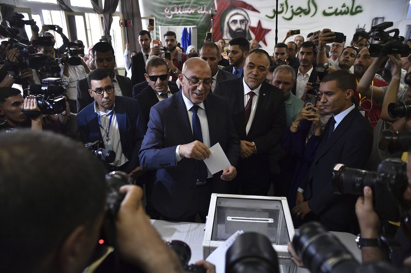 Presidential candidate of the Movement of Society for Peace (MSP), Abdelali Hassani Cherif, prepares to cast his ballot inside a polling station during the presidential election, Saturday, Sept. 7, 2024, in Algiers, Algeria. (AP Photo/Fateh Guidoum)