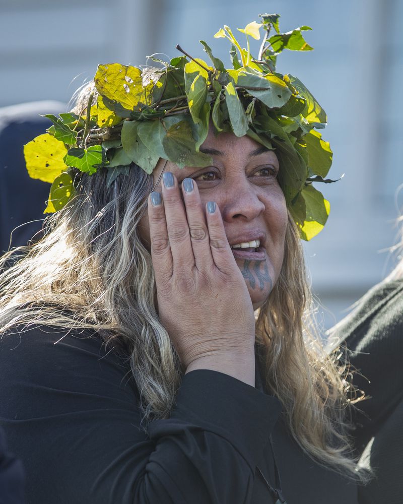 A mourner reacts outside Turangawaewae Marae for the funeral of New Zealand's Māori King, Kiingi Tuheitia Pootatau Te Wherowhero VII, in Ngaruawahia, New Zealand, Thursday, Sept 5, 2024. (AP Photo/Alan Gibson)