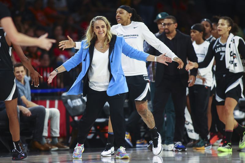 Las Vegas Aces coach Becky Hammon welcomes players during a timeout during the first half of the team's WNBA basketball game against the Seattle Storm on Friday, June 7, 2024, in Las Vegas. (Ellen Schmidt/Las Vegas Review-Journal via AP)