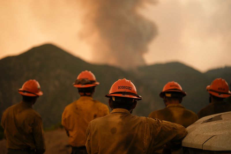 Members of the Mill Creek Hotshots monitor the Line Fire Monday, Sept. 9, 2024, near Angelus Oaks, Calif. (AP Photo/Gregory Bull)