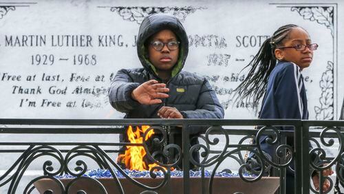 Malik Shaeer, 12, left, and Deja Reynolds, 12, from Minneapolis, visit the crypt of Martin Luther King Jr. and Coretta Scott King in Atlanta. (John Spink/The Atlanta Journal-Constitution/TNS)