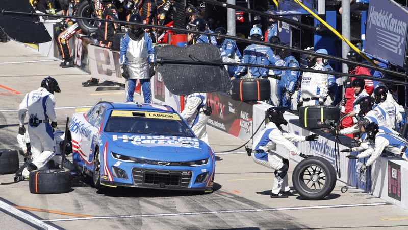 Kyle Larson (5) stops for a tire change during a NASCAR Cup Series auto race at Kansas Speedway in Kansas City, Kan., Sunday, Sept. 29, 2024. (AP Photo/Colin E. Braley)