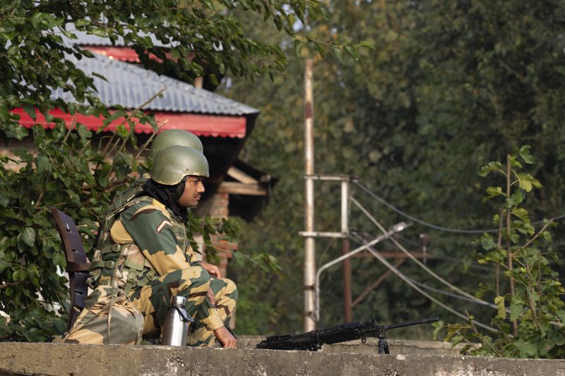 Indian paramilitary soldiers guard a polling station during the second phase of the assembly election in the outskirts of Srinagar, Indian controlled Kashmir, Wednesday, Sept. 25, 2024. (AP Photo/Dar Yasin)