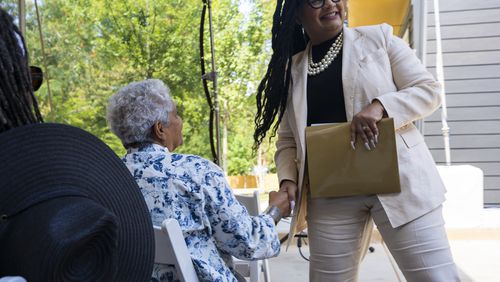 U.S. Representative Nikema Williams shakes hands with former Atlanta Mayor Shirley Franklin at an Atlanta Neighborhood Development Partnership Inc.  housing unveiling event on Tuesday, Aug. 27, 2024 in Atlanta, Georgia. (Olivia Bowdoin for the AJC). 