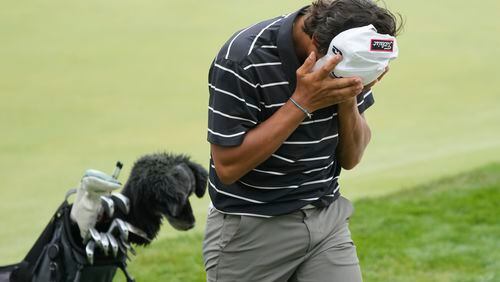 Charlie Woods walks off the 18th green during the first round of stroke play of the U.S. Junior Amateur Golf Championship, Monday, July 22, 2024, in Bloomfield Township, Mich. (AP Photo/Carlos Osorio)