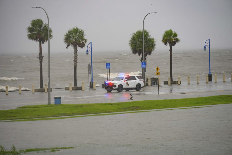 Orleans Levee District Police patrol Lakeshore Drive along Lake Ponchartrain as wind and rain pick up from Hurricane Francine in New Orleans, Wednesday, Sept. 11, 2024. (AP Photo/Matthew Hinton)