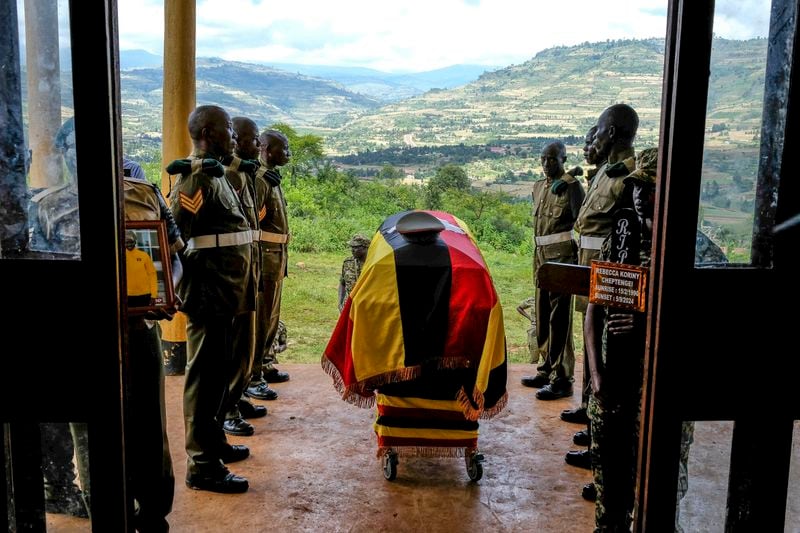 Members of Uganda People's Defence Force (UPDF) stand at the casket of their colleague Ugandan Olympic athlete Rebecca Koriny Cheptegei, ahead of her burial in Kapkoros, Bukwo District, Uganda Saturday, Sept. 14. 2024. (AP Photo/Hajarah Nalwadda)