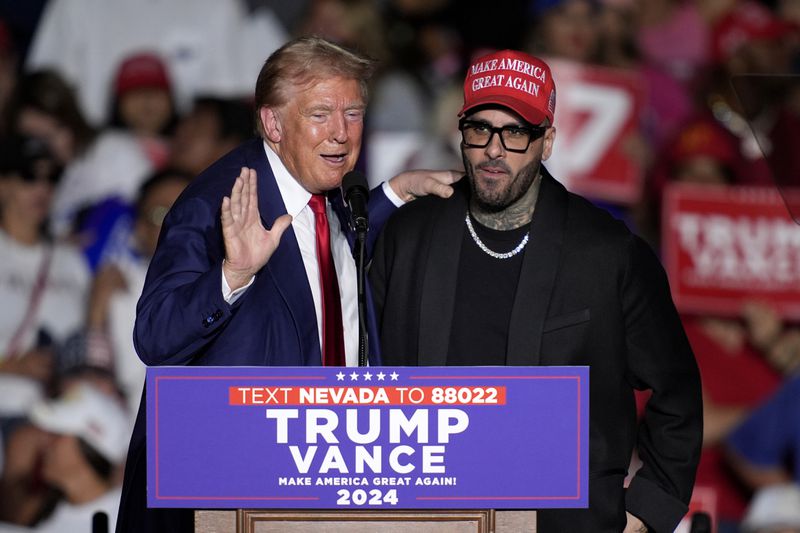 Republican presidential nominee former President Donald Trump, left, greets Nicky Jam during a campaign event at the World Market Center, Friday, Sept.13, 2024, in Las Vegas. (AP Photo/John Locher)