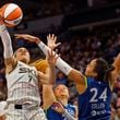 Chicago Sky guard Chennedy Carter (7) goes to the basket as Minnesota Lynx guard Kayla McBride, center, and forward Napheesa Collier (24) guard against her in the third quarter of a WNBA basketball game Friday, Sept. 13, 2024, in Minneapolis. (AP Photo/Bruce Kluckhohn)