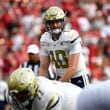 Georgia Tech quarterback Haynes King (10) looks out over the Louisville defensive line before the snap during the first half of an NCAA college football game in Louisville, Ky., Saturday, Sept. 21, 2024. Louisville won 31-19. (AP Photo/Timothy D. Easley)