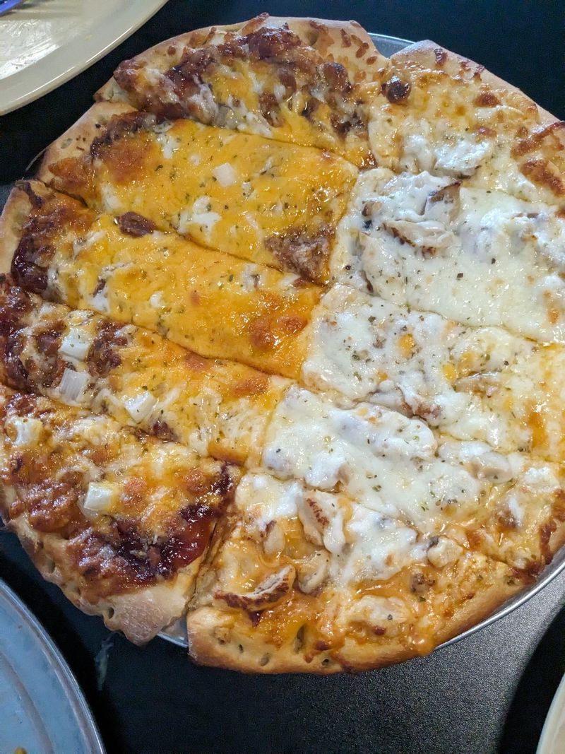 This pie from Generations Pizza is half barbecue pulled pork and half buffalo chicken. Courtesy of Paula Pontes