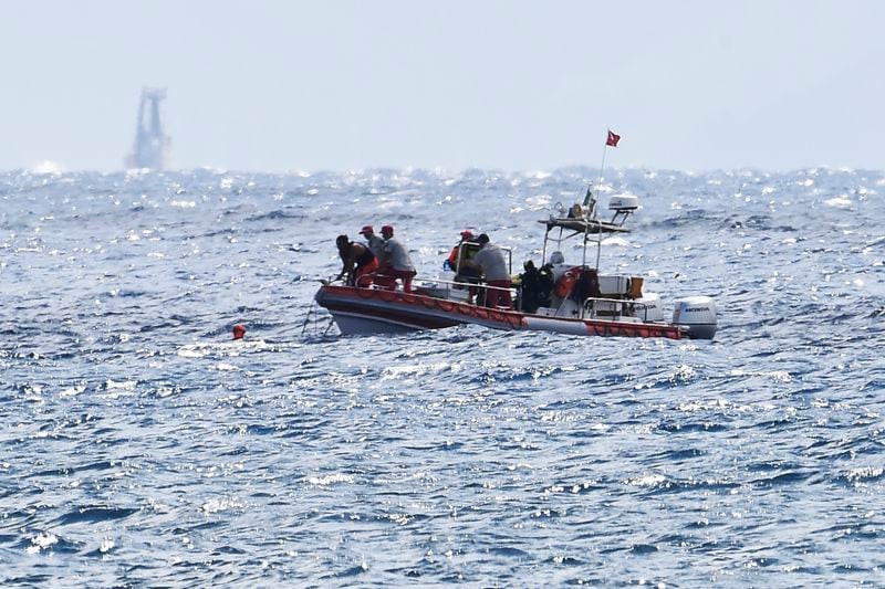 Scuba divers of the Italian Firefighters corp at the scene of the search for a missing boat, in Porticello, southern Italy, Tuesday, Aug. 20, 2024. Rescue teams and divers returned to the site of a storm-sunken superyacht Tuesday to search for six people, including British tech magnate Mike Lynch, who are believed to be still trapped in the hull 50 meters (164-feet) underwater. (AP Photo/Salvatore Cavalli)