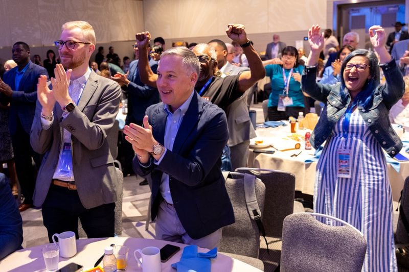 Attendees, including Matthew Wilson (center), first vice chair of the Democratic Party of Georgia, cheer at the Georgia delegation breakfast in Chicago on Monday.