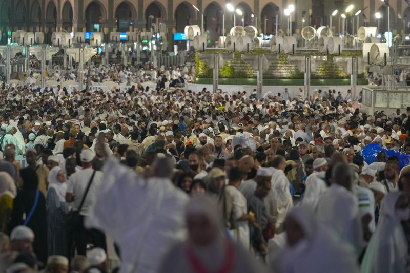 Muslim pilgrims arrive to offer prayers at the Grand Mosque, during the annual Hajj pilgrimage in Mecca, Saudi Arabia, Tuesday, June 11, 2024. (AP Photo/Rafiq Maqbool)