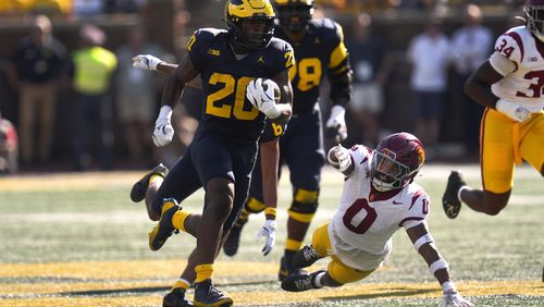 Michigan running back Kalel Mullings (20) runs for a 53-yard touchdown as Southern California safety Akili Arnold (0) defends in the first half of an NCAA college football game in Ann Arbor, Mich., Saturday, Sept. 21, 2024. (AP Photo/Paul Sancya)