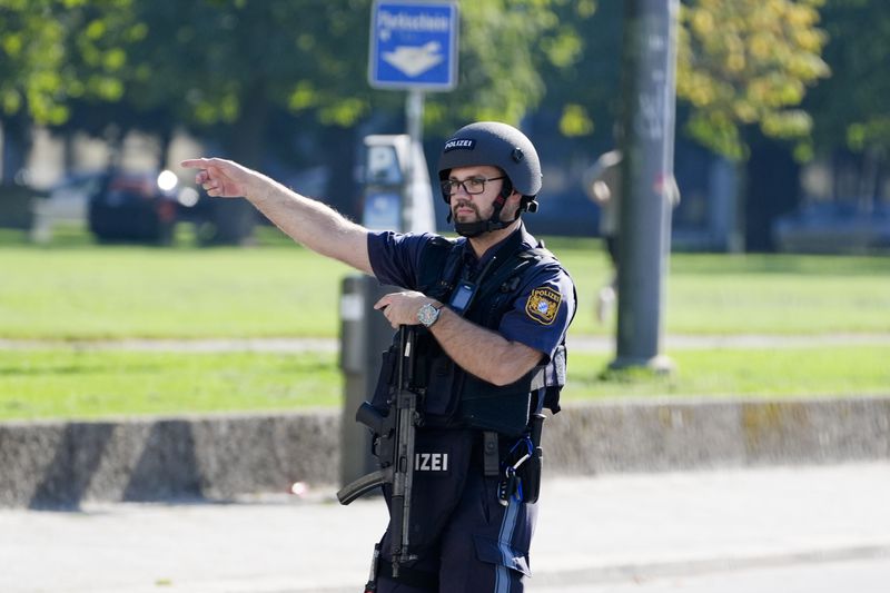 A police officer patrols after police fired shots at a suspicious person near the Israeli Consulate and a museum on the city's Nazi-era history in Munich, Germany, Thursday, Sept. 5, 2024. (AP Photo/Matthias Schrader)