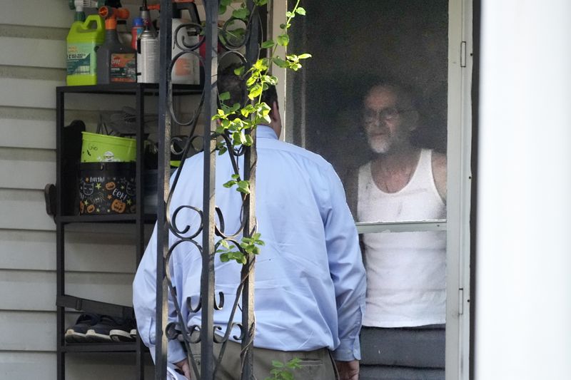 Ernie Bevilacqua, right, declined to talk to a reporter after answering his door at his home in Greensburg, Pa., on April 29, 2024. Bevilacqua is among four jailhouse informants whose testimony put Steve Szarewicz behind bars for life on a murder conviction. (AP Photo/Gene J. Puskar)