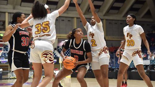 March 11, 2021 Macon - Woodward Academy's Sara Lewis (2) prepares to shoot between Forest Park's Yasmine Allen (35) and Woodward Academy's Sara Lewis (2) during the 2021 GHSA State Basketball Class AA Boys Championship game at the Macon Centreplex in Macon on Thursday, March 11, 2021 Pace Academy won 73-42 over Columbia. (Hyosub Shin / Hyosub.Shin@ajc.com)