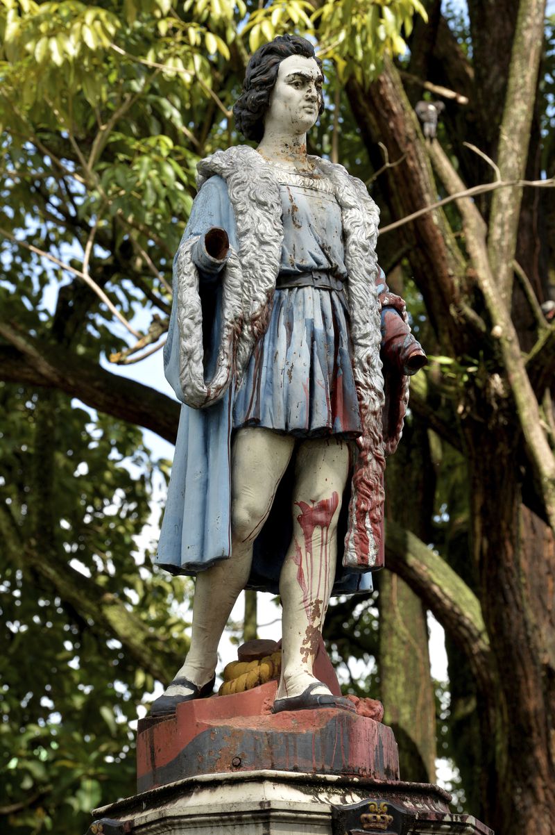 A vandalized statue of Christopher Columbus stands in Columbus Square in Port of Spain, Trinidad and Tobago, Wednesday, Aug. 28, 2024. Officials in the Caribbean island nation are reviewing on whether to remove statues, signs and monuments that reference European colonization. (AP Photo/Robert Taylor)