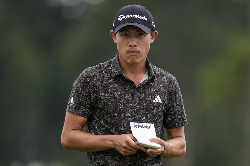 Collin Morikawa stands on the third green during the final round of the Tour Championship golf tournament, Sunday, Sept. 1, 2024, in Atlanta. (AP Photo/Mike Stewart)