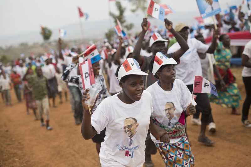 FILE - Supporters of Rwanda's President Paul Kagame, center, attend an election campaign rally on the hills overlooking Kigali, Rwanda, on Aug. 2, 2017. Rwandans are voting Monday in an election that will almost certainly extend the long rule of Kagame, who is running virtually unopposed after three decades in power in the eastern African nation. (AP Photo/Jerome Delay, File)