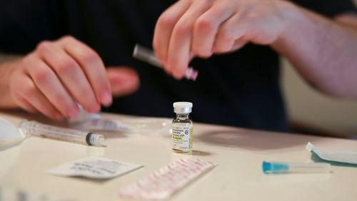 FILE - Lucas prepares his weekly testosterone shot at his home in Casselberry, Fla., May 29, 2023. The Associated Press is not using Lucas' last names because he fears reprisal. (AP Photo/Laura Bargfeld, File)