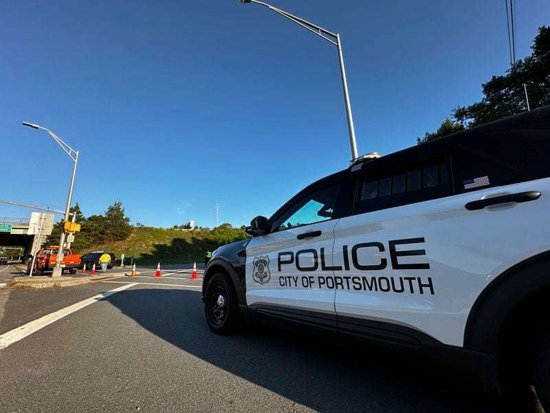 Police block a ramp to Interstate 95 and the Piscataqua River Bridge in Portsmouth, N.H., after a man connected to a homicide was fatally shot by police, and an 8-year-old child was found shot to death in the man’s car, on the bridge that connects New Hampshire to Maine, Thursday, Aug. 29, 2024. (AP Photo/Caleb Jones)