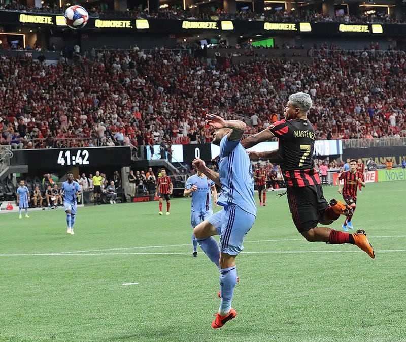 Atlanta United forward Josef Martinez goes up for a header over New York City FC defender Maxime Chanot for a record-setting goal Sunday, Aug. 11, 2019, at Mercedes-Benz Stadium in Atlanta.