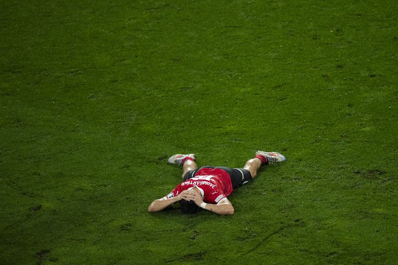Austria's Christoph Baumgartner lays on the pitch after his team lose a round of sixteen match against Turkey 1-2 at the Euro 2024 soccer tournament in Leipzig, Germany, Tuesday, July 2, 2024. (AP Photo/Ebrahim Noroozi)
