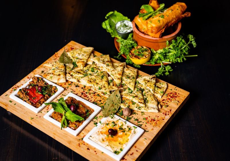 A mezza platter with hummus, moussaka and zaalouk (left) and cheese samboska (right) at Pharaohs Palace. CONTRIBUTED BY HENRI HOLLIS