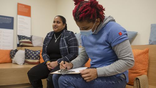 Applicants Jasmine Lee (left) and Tedra Hill (right) sign up for a position during a job fair at TTEC Duluth on Tuesday, December 13, 2022, in Duluth, Georgia. The customer service company recruited, interviewed and onboarded new employees at the event. CHRISTINA MATACOTTA FOR THE ATLANTA JOURNAL-CONSTITUTION.