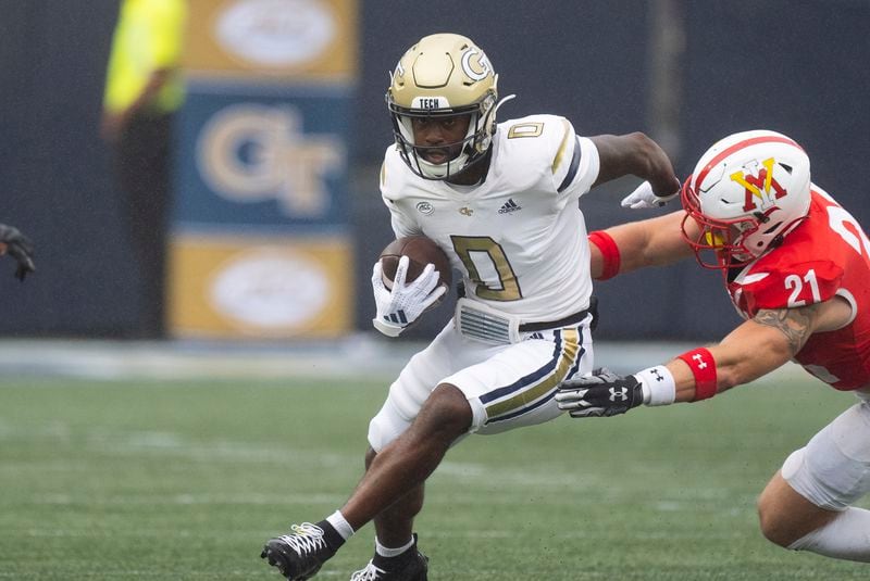 Georgia Tech wide receiver Christian Leary (0) runs afte r a catch as Virginia Military Institute linebacker Camden Clinton (21) defends during the first half of a NCAA college football game Saturday, Sept. 14, 2024, in Atlanta,. (AP Photo/John Bazemore)