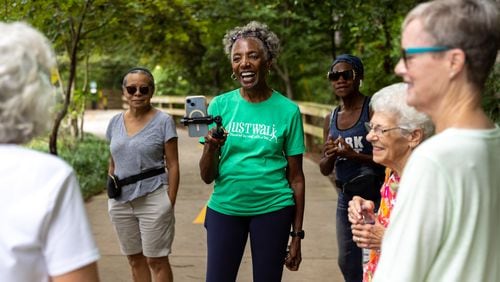 Carolyn Hartfield (center), leader of a walking group, gathers with the group before a walk at Mason Mill park in Decatur. (Arvin Temkar / AJC)