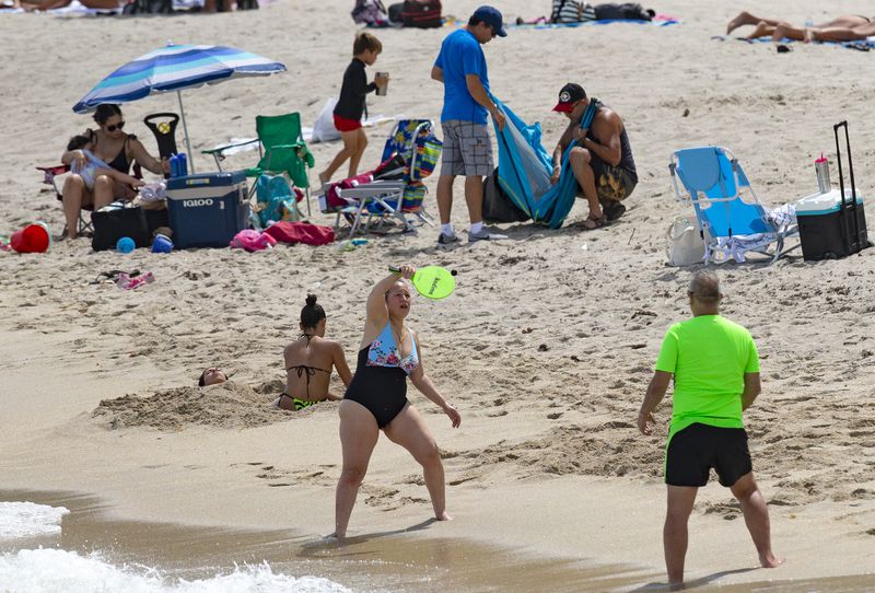 FILE - Beachgoers enjoyed the sunny and hot day at Sunny Isles Beach as the coronavirus pandemic continues on Sunday, Sept. 6, 2020. (David Santiago/Miami Herald via AP, file)