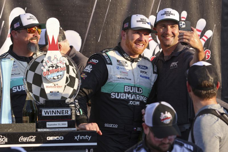 Chris Buescher's (17) team celebrates after winning a NASCAR Cup Series auto race, Sunday, Sept. 15, 2024, in Watkins Glen, N.Y. (AP Photo/Lauren Petracca)