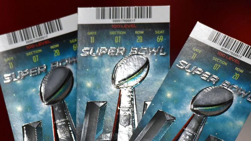 NFL Senior Counsel of Legal Affairs Michael Buchwald holds up Super Bowl 51 tickets as he explains the anti-counterfeit features of legitimate tickets during a news conference at the George R. Brown Convention Center in Houston on Thursday, Feb. 2, 2017.