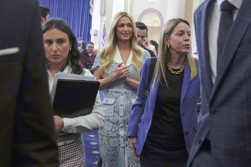 Paris Hilton, center, departs after a House committee meeting on Capitol Hill on Wednesday.