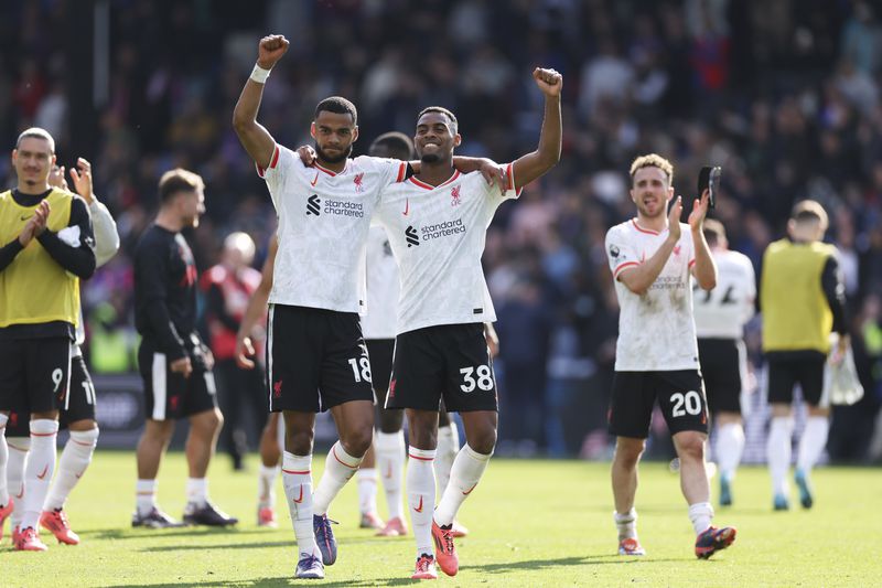 Liverpool's Cody Gakpo, centre left, Ryan Gravenberch, centre, and Diogo Jota celebrate after the English Premier League soccer match between Crystal Palace and Liverpool at Selhurst Park in London, Saturday, Oct. 5, 2024.(AP Photo/Ian Walton)