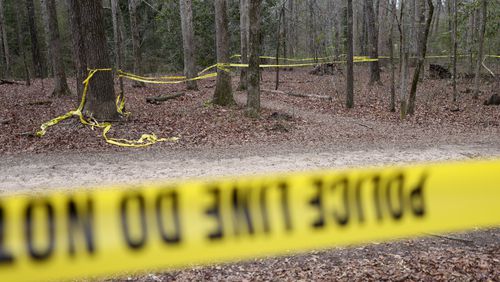 Police tape ropes off the crime scene on a trail behind Lake Herrick in Athens at the University of Georgia on Friday, Feb. 23, 2024. A female nursing student was found dead nearby the day before. (Jason Getz / jason.getz@ajc.com)