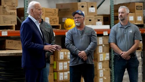 President Joe Biden, left, meets with workers from Dairyland Power Cooperative and Vernon Electric Cooperative during a visit to Vernon Electric in Westby, Wis., Thursday, Sept. 5, 2024. Biden is in Wisconsin to promote his Investing in America agenda. (AP Photo/Susan Walsh)