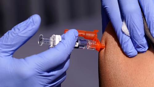 FILE - A patient is given a flu vaccine Oct. 28, 2022, in Lynwood, Calif. On Tuesday, July 2, 2024, the U.S. Department of Health and Human Services announced plans to pay Moderna $176 million to develop a mRNA vaccine to treat bird flu in people, as cases in dairy cows continue to mount across the country. (AP Photo/Mark J. Terrill, File)