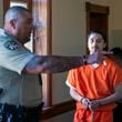 FILE - Ryan Martinez is led into court for a preliminary and detention hearing at the Rio Arriba Courthouse, in Tierra Amarilla, N.M., Friday, Oct. 13, 2023. (Eddie Moore/The Albuquerque Journal via AP, File)