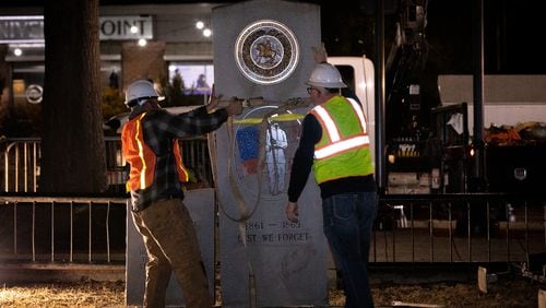 A crew works to remove a Confederate monument from its place on the grounds of the Gwinnett Historic Courthouse in Lawrenceville, Ga., on Thursday, Feb. 4, 2021. The Gwinnett County Board of Commissioners voted unanimously on January 19 to remove the monument, overturning the decision of their predecessors from almost three decades prior. In 1993, county commissioners gave permission for the monument to be installed at the request of the United Daughters of the Confederacy. (Casey Sykes for The Atlanta Journal-Constitution)