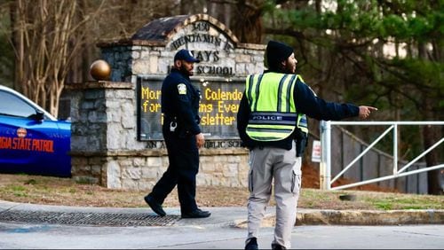 Police direct traffic outside Benjamin E. Mays High School in Atlanta on Wednesday after four students were shot.