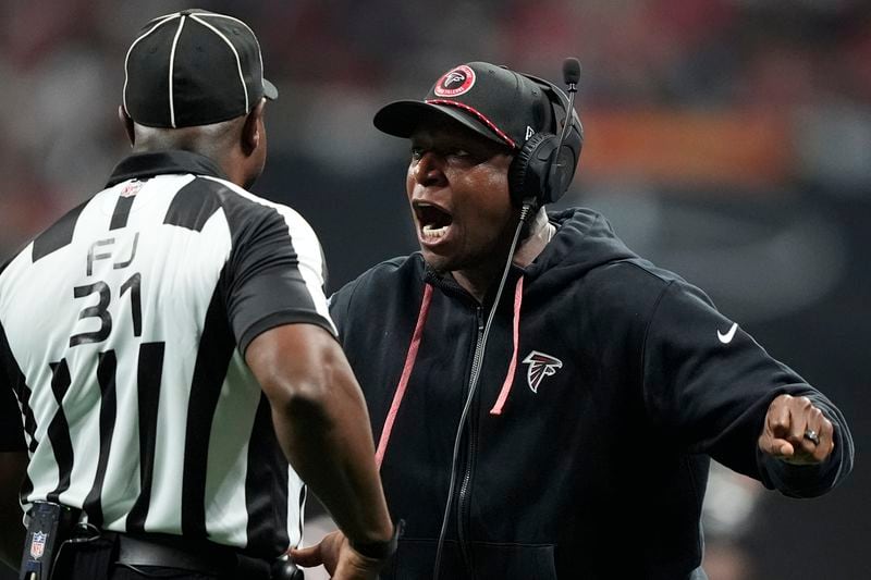 Atlanta Falcons head coach Raheem Morris speaks with field judge Mearl Robinson (31) during the first half of an NFL football game against the Kansas City Chiefs, Sunday, Sept. 22, 2024, in Atlanta. (AP Photo/Brynn Anderson)