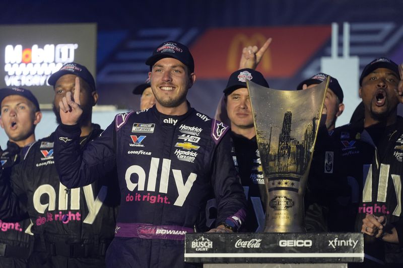 Alex Bowman stands with his team and his trophy after winning a NASCAR Cup Series auto race, Sunday, July 7, 2024, in Chicago. (AP Photo/Erin Hooley)