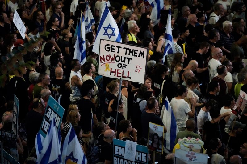 People protest against Prime Minister Benjamin Netanyahu's government and call for the release of hostages held in the Gaza Strip by the Hamas militant group, in Tel Aviv, Israel, Saturday, Sept. 14, 2024. (AP Photo/Mahmoud Illean)